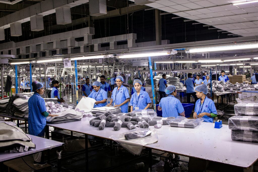 Indian textile factory workers expertly packaging products on an assembly line.